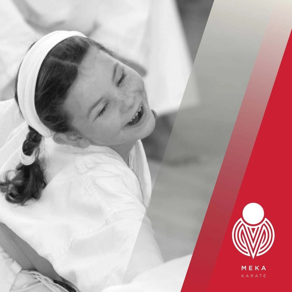 Young child smiling while training karate in class