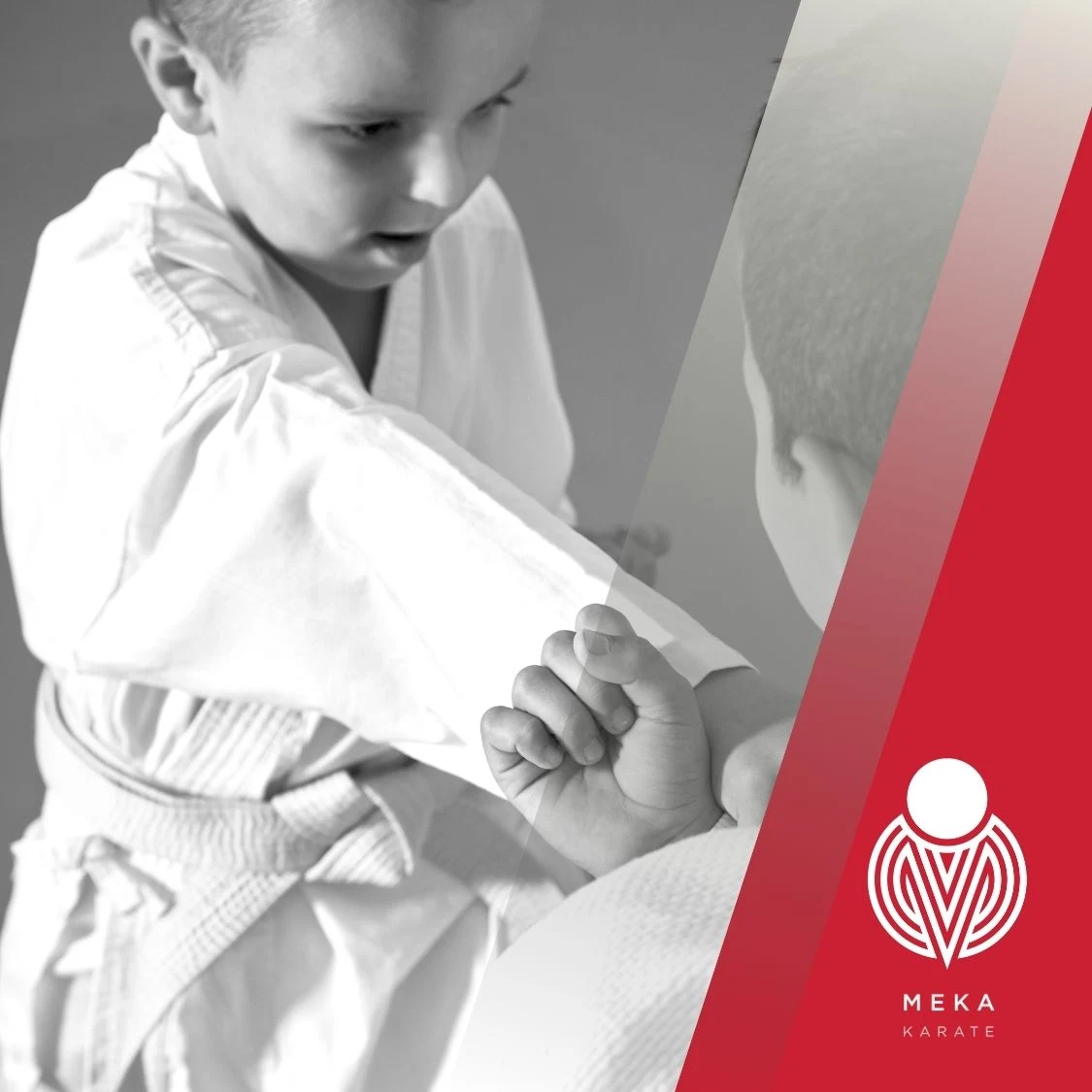 Young boy practising karate with a focused body punch in training