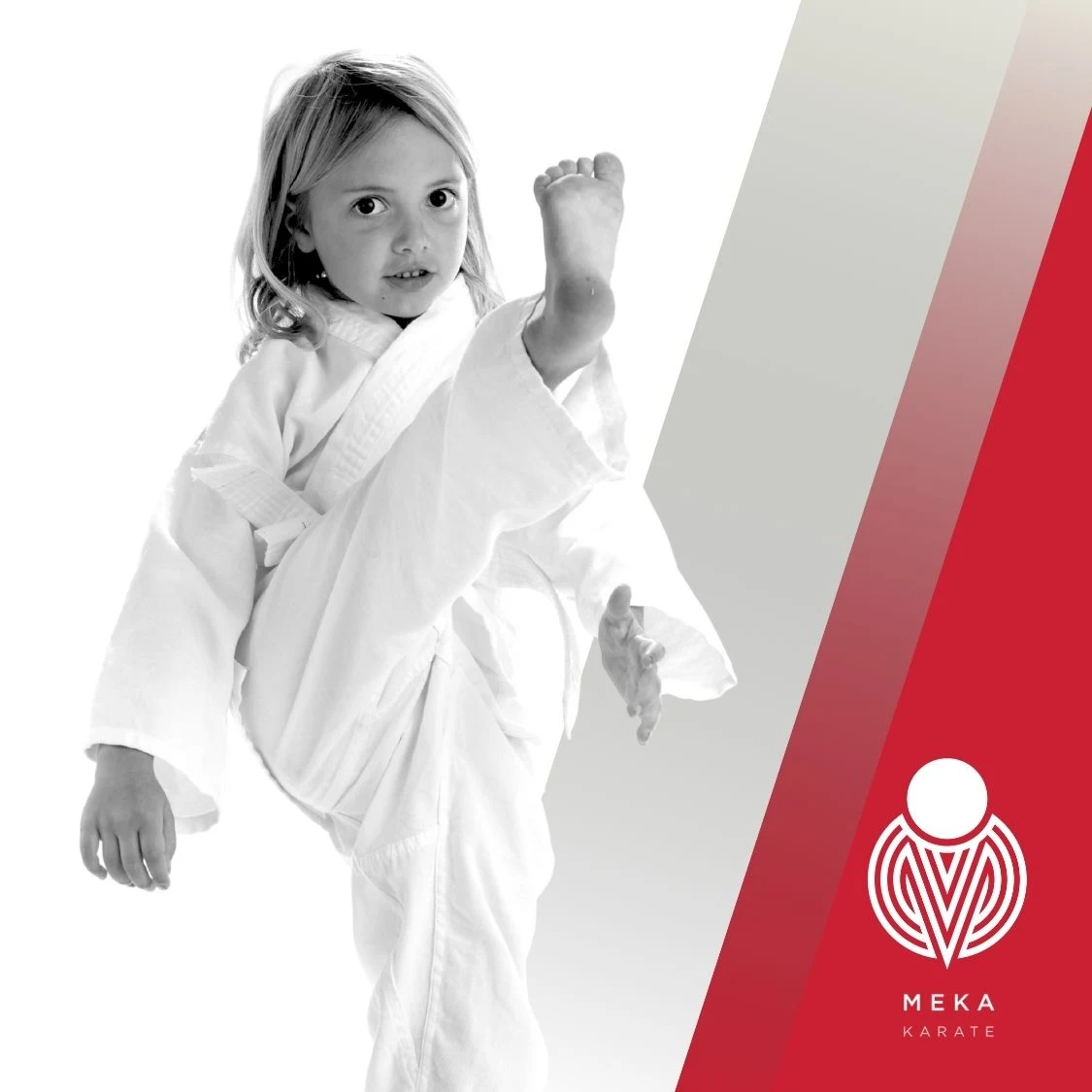 Young girl in karate uniform performing a high kick during martial arts training